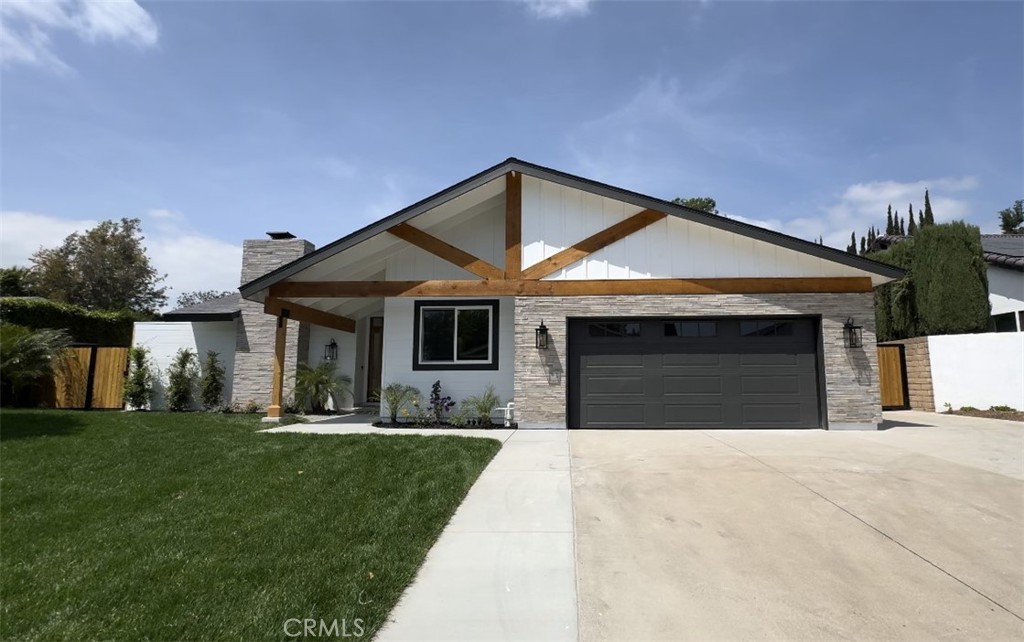 Finished modern farmhouse exterior with stone and timber gables
