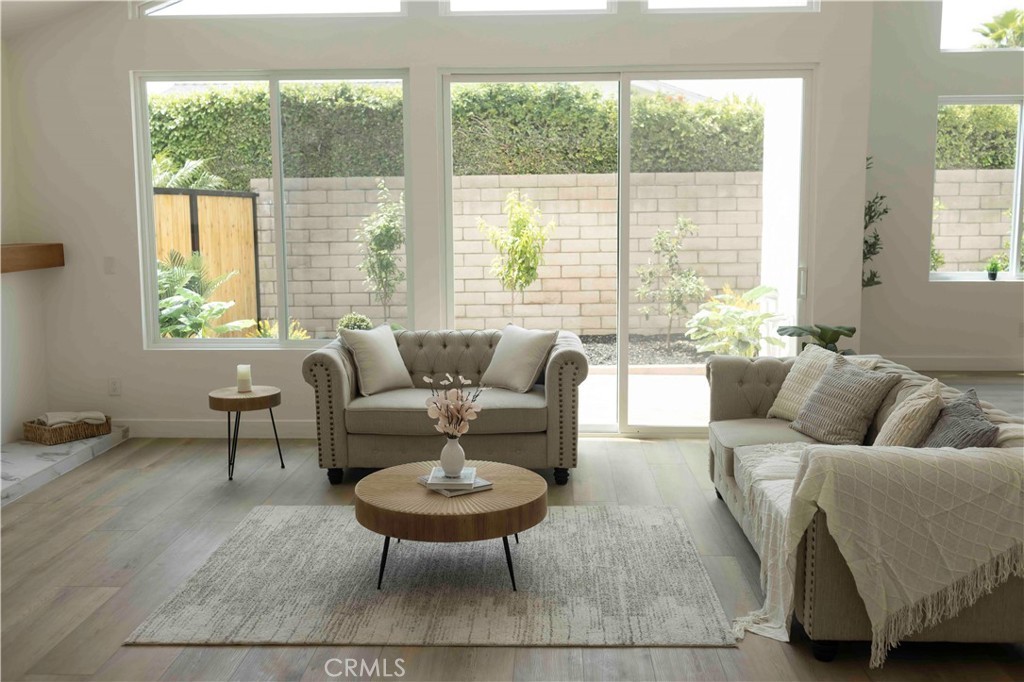 Remodeled living room with walls of glass opening to the backyard