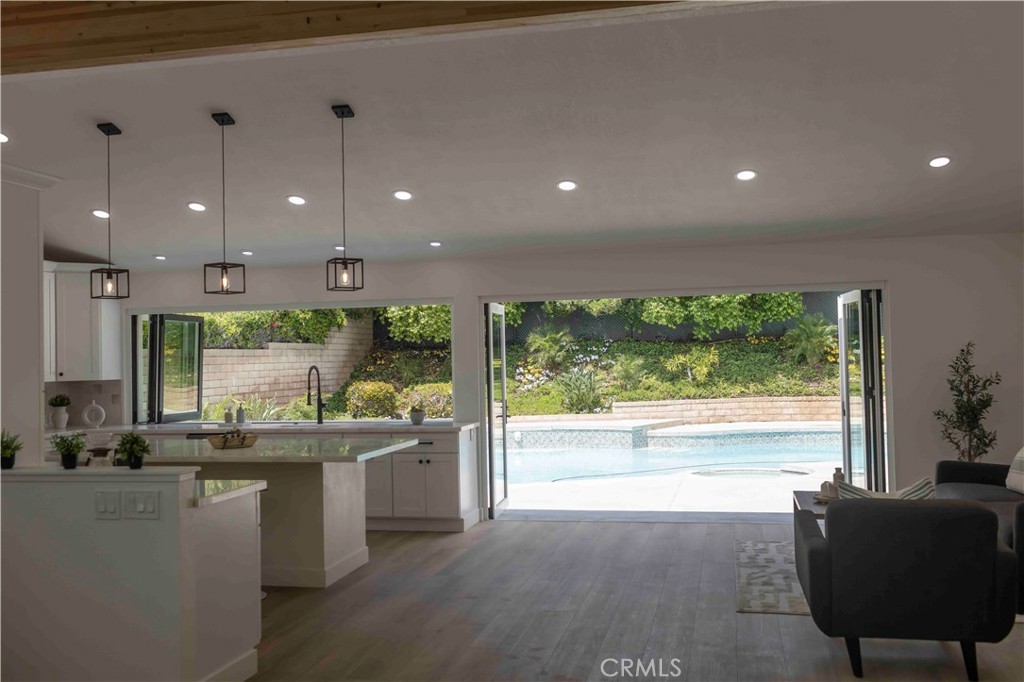 Kitchen opening to pool through bifold doors